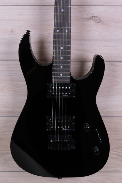 A black electric guitar with a glossy finish, resting vertically against a light wood plank wall. The headstock features the 'Aldam' brand logo in white script.