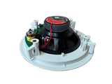 A ceiling fan speaker assembly with a black cone driver, white plastic mounting bracket, and internal circuit board, resting on a light wood floor.