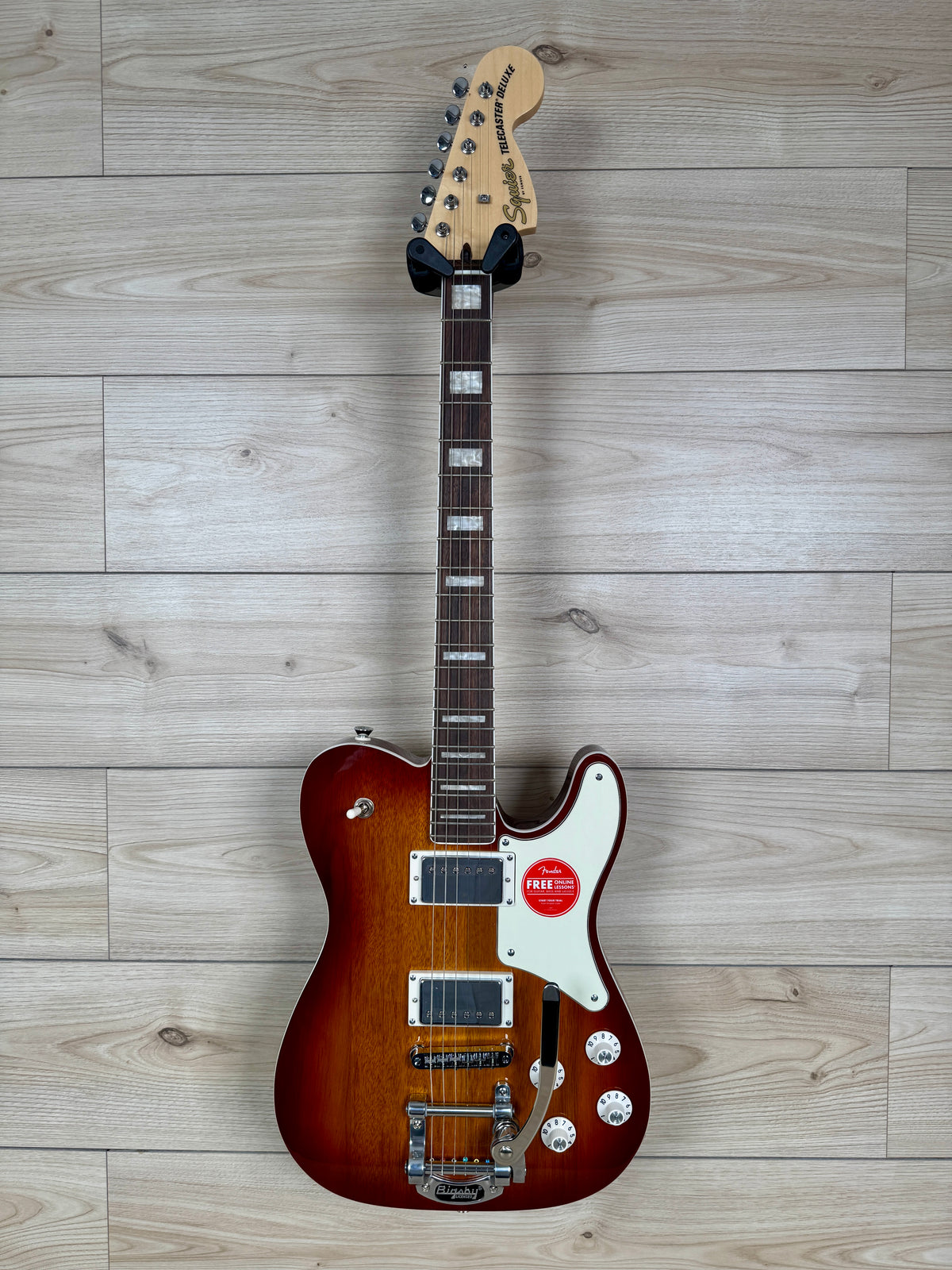 A Squier Telecaster electric guitar in a sunburst finish.